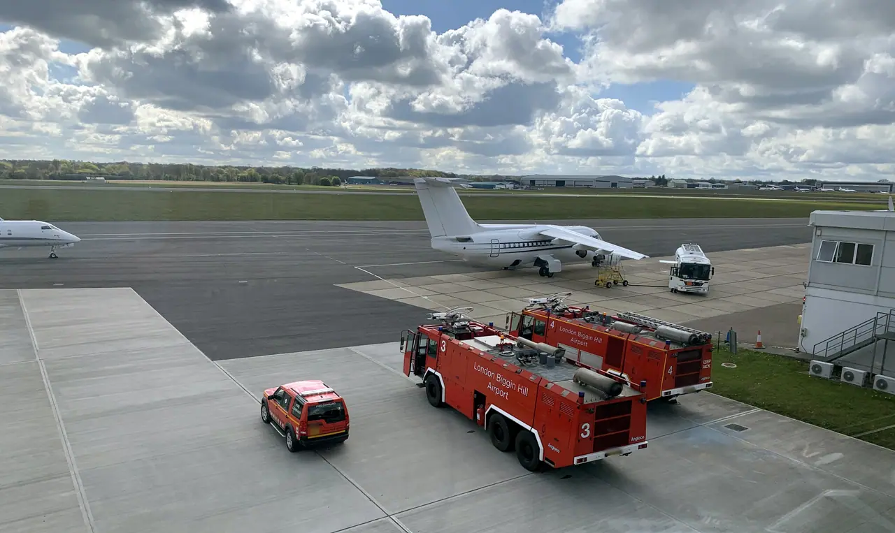 The apron and runway at London Biggin Hill Airport, with the airport fire service’s vehicles in the foreground