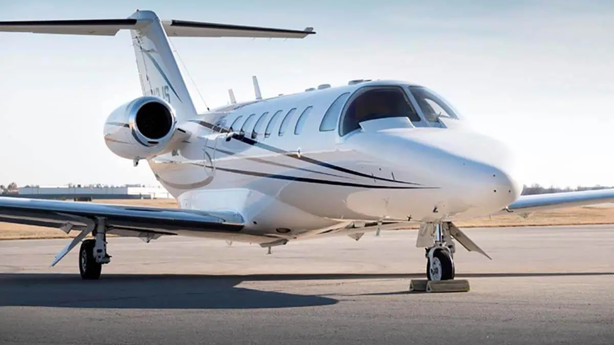 Light private jet parked on the apron
