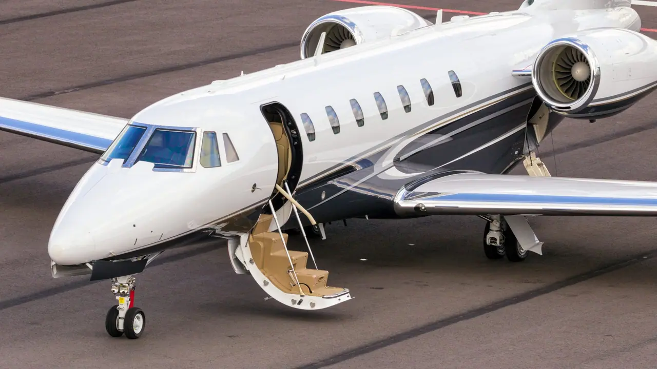 Private jet with its cabin door open and steps down