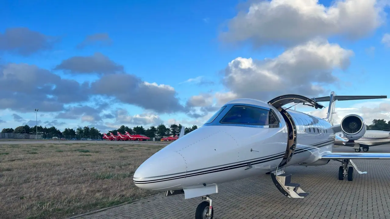 A private jet with its door open, ready for boarding