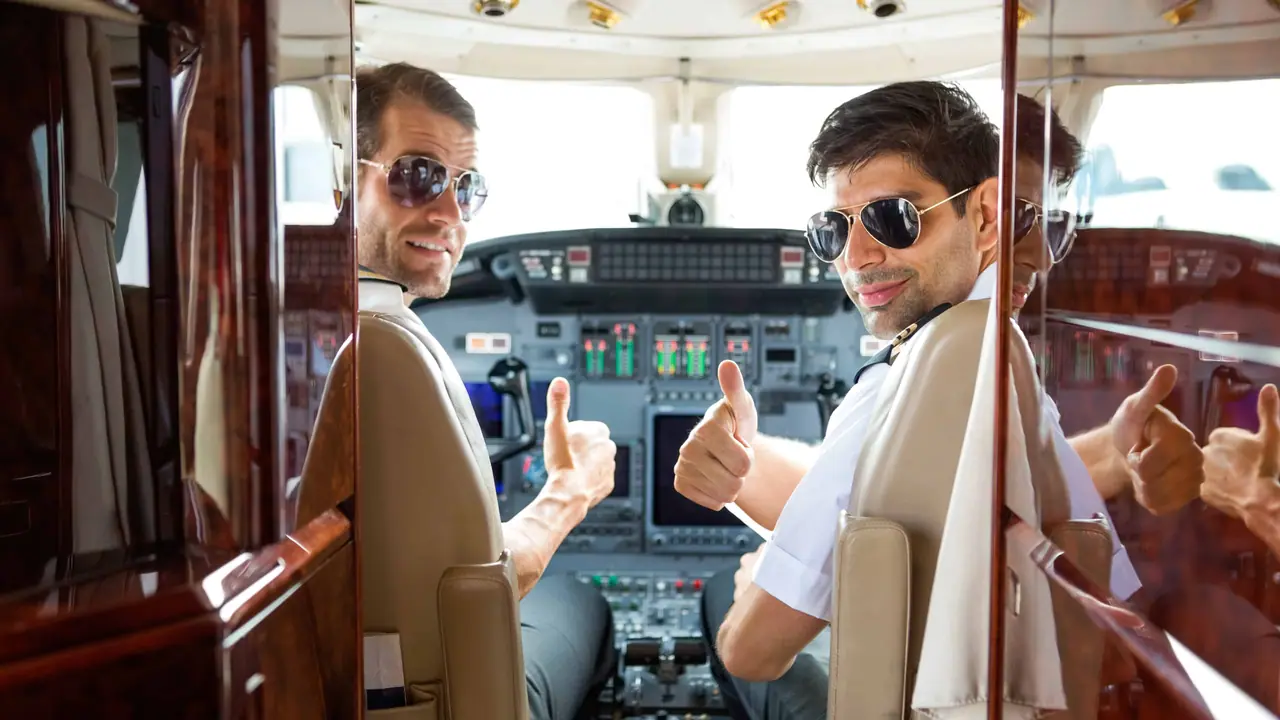 Two pilots at the controls of a private jet