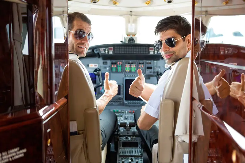 Two pilots in the cockpit of a private jet