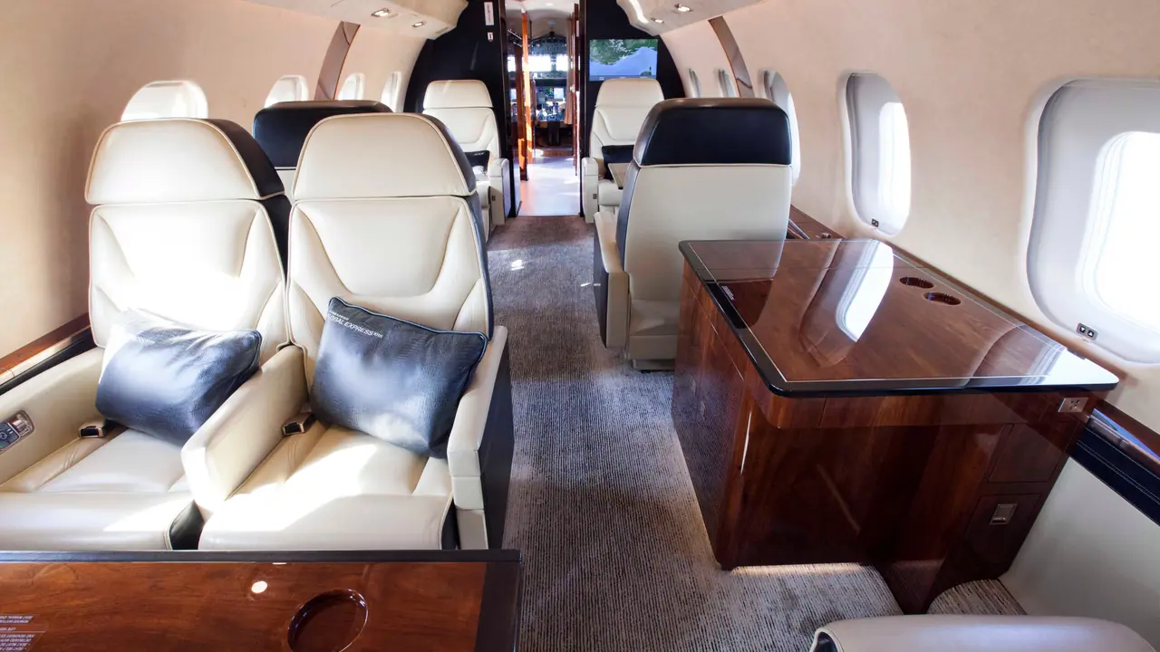 Cabin of an ultra-long-range private jet with cream leather seats